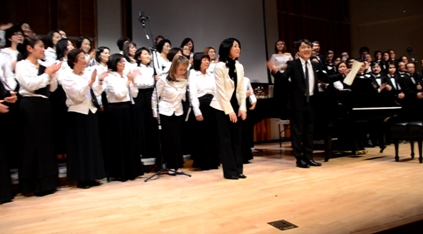 Mayuzumi, center, and composer Akira Senju, right, with the members of Japan Choral Harmony and the Men