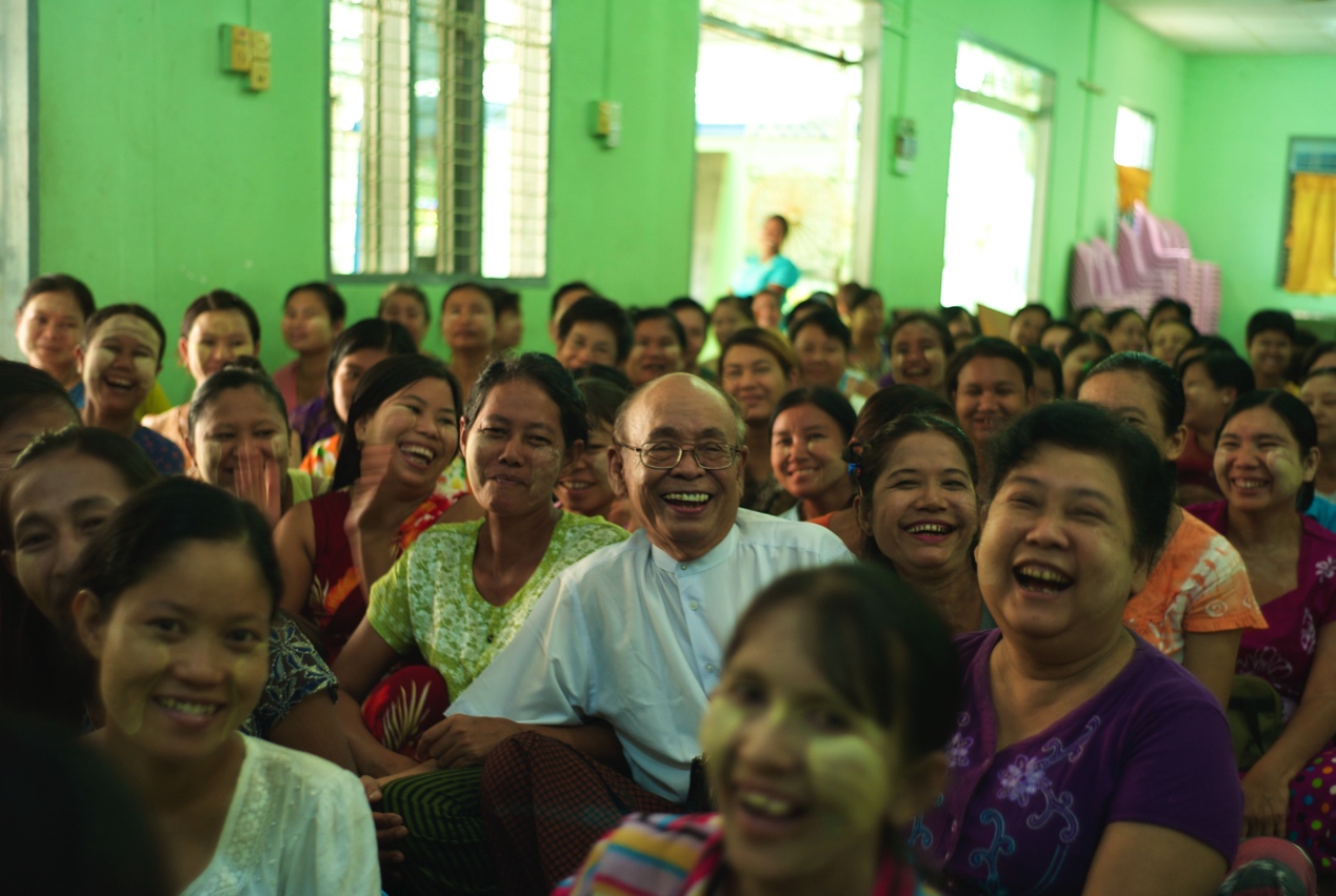 Customers gather at a community center in Myanmar. In the center is the president of Gojo’s local subsidiary.